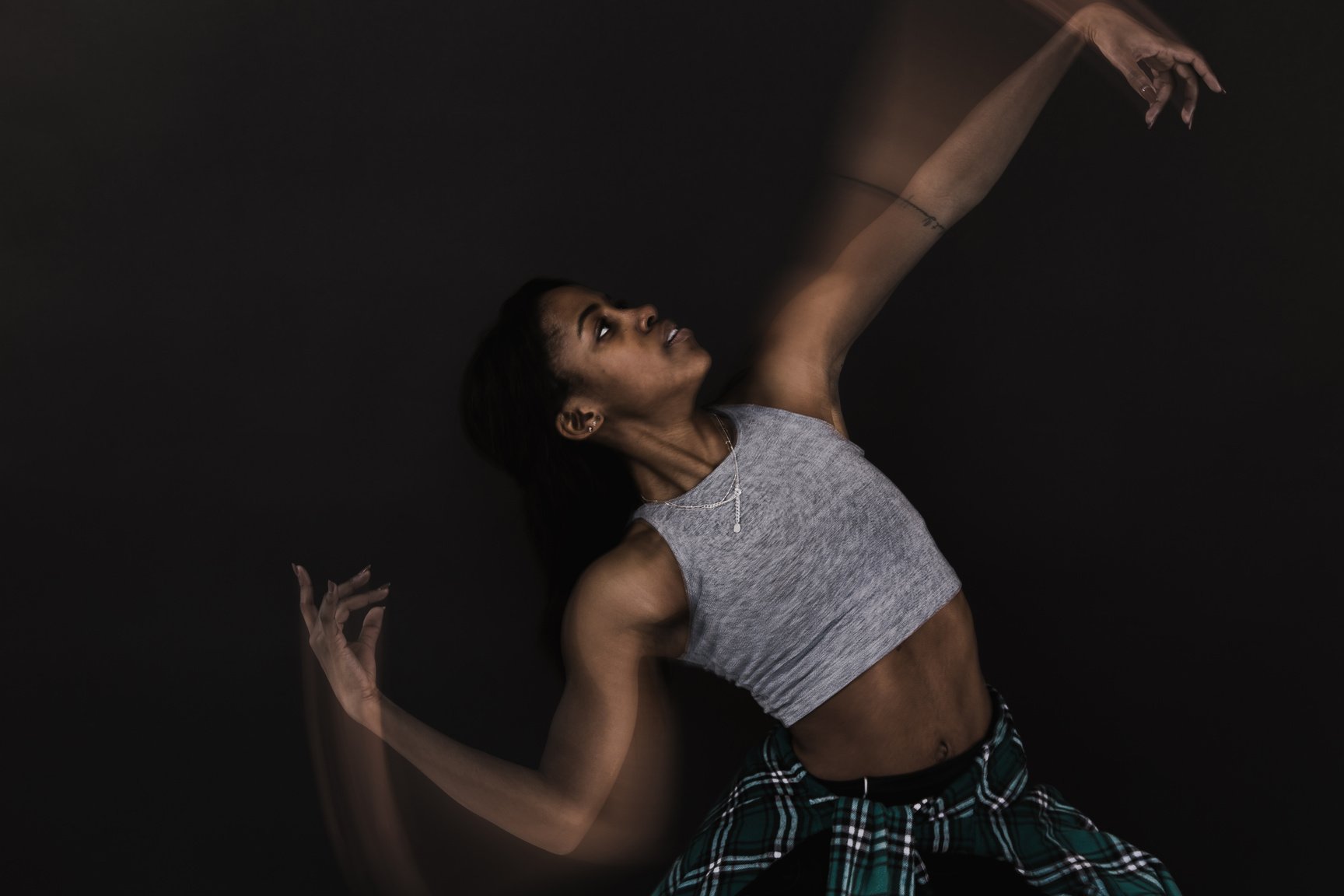 Female Performer Dancing on Black Background